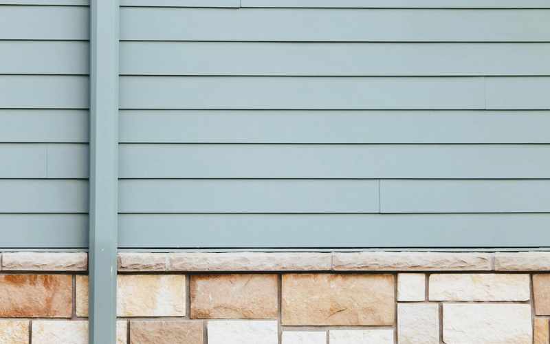 White trim detail around a window on a light-colored exterior wall